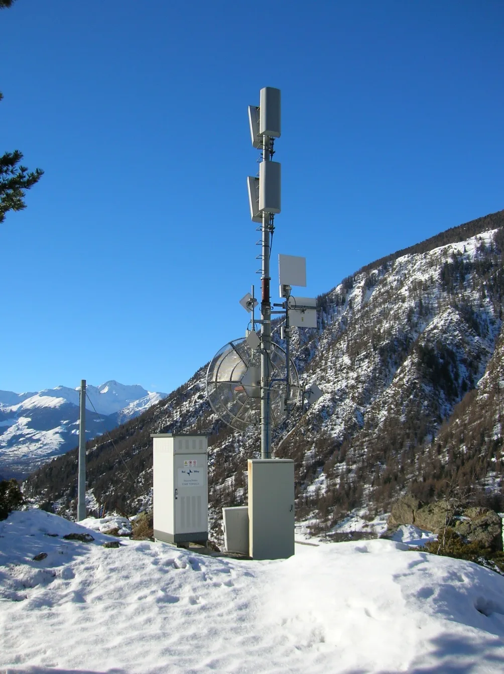Transmission station on a mountain pylon, in the snow